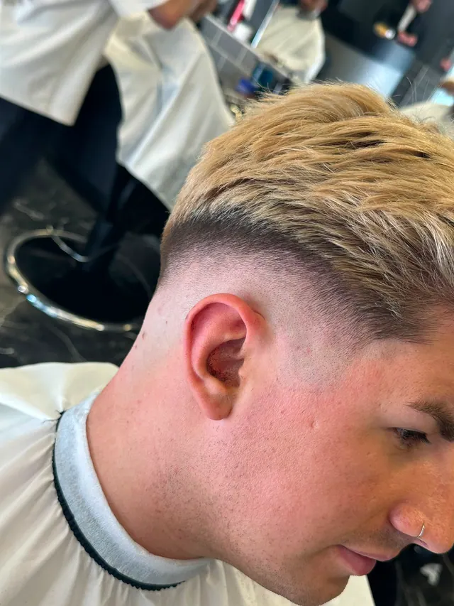 A blond textured cut with a low fade, seen from above
