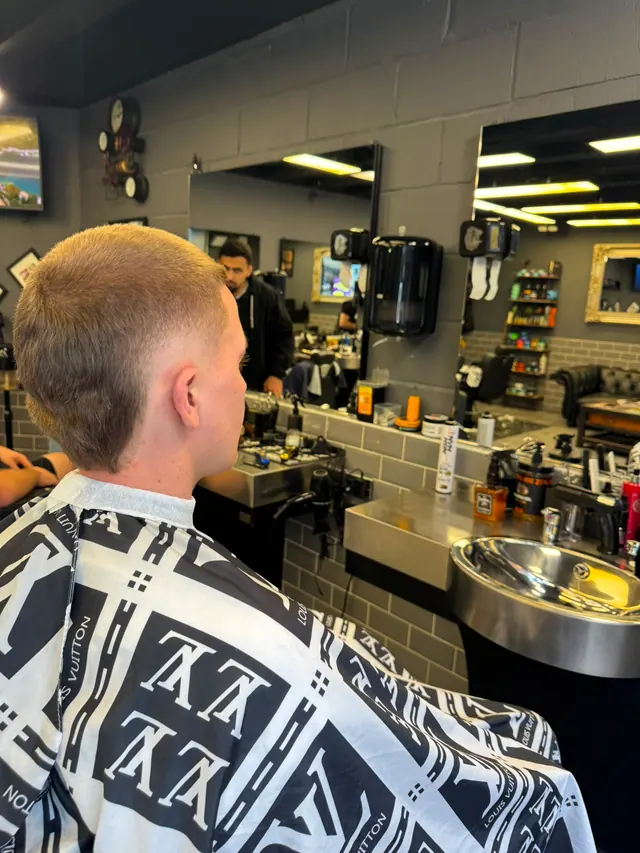 A short blond crop with a taper, side view