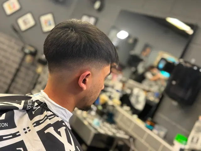 A heavy fringe with a skin fade, close up