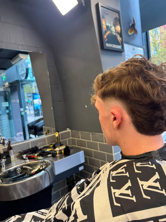 A longer textured cut with a taper, by the window