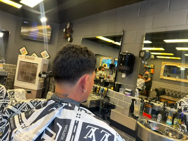 A client in the chair among the mirrors and stations