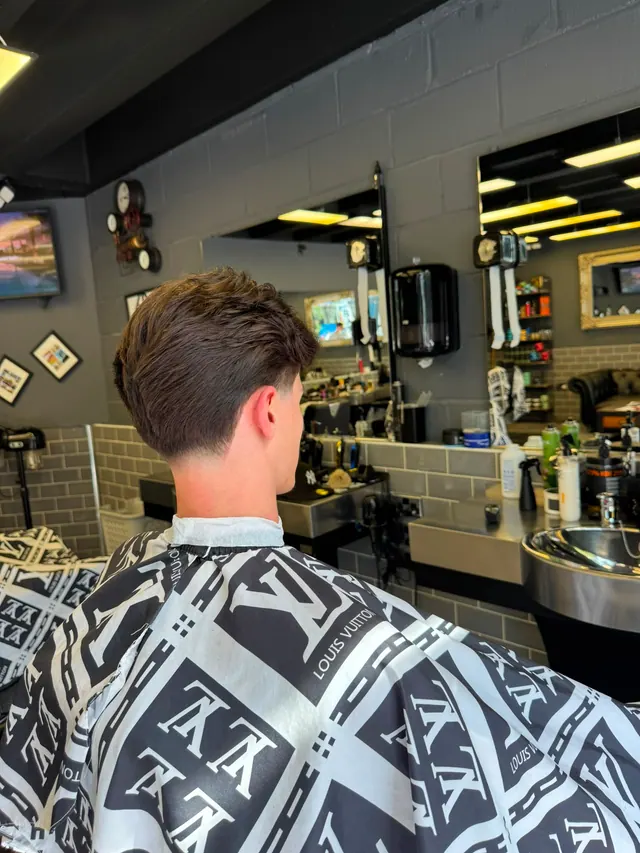 A tapered cut from behind, the mirrors and stations beyond