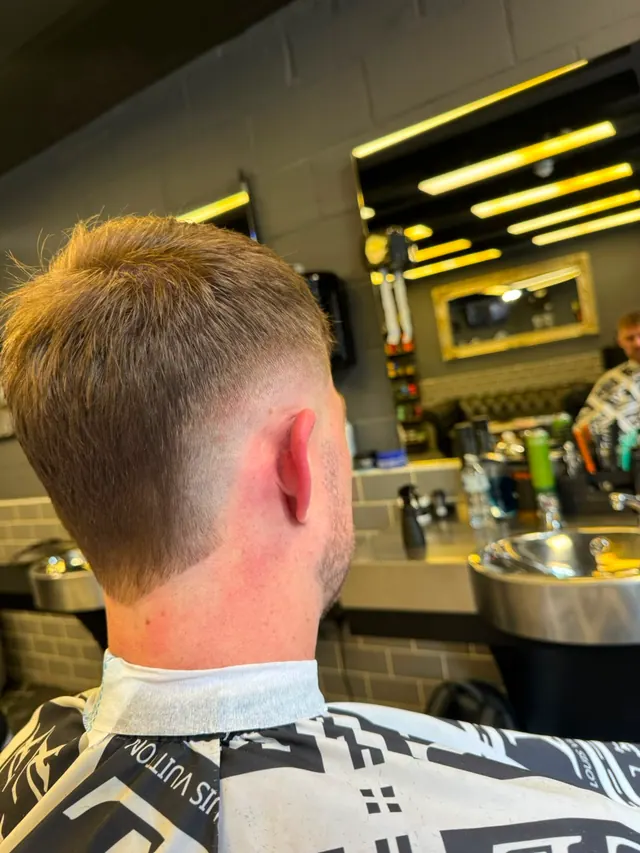 A tapered crop, seen from behind