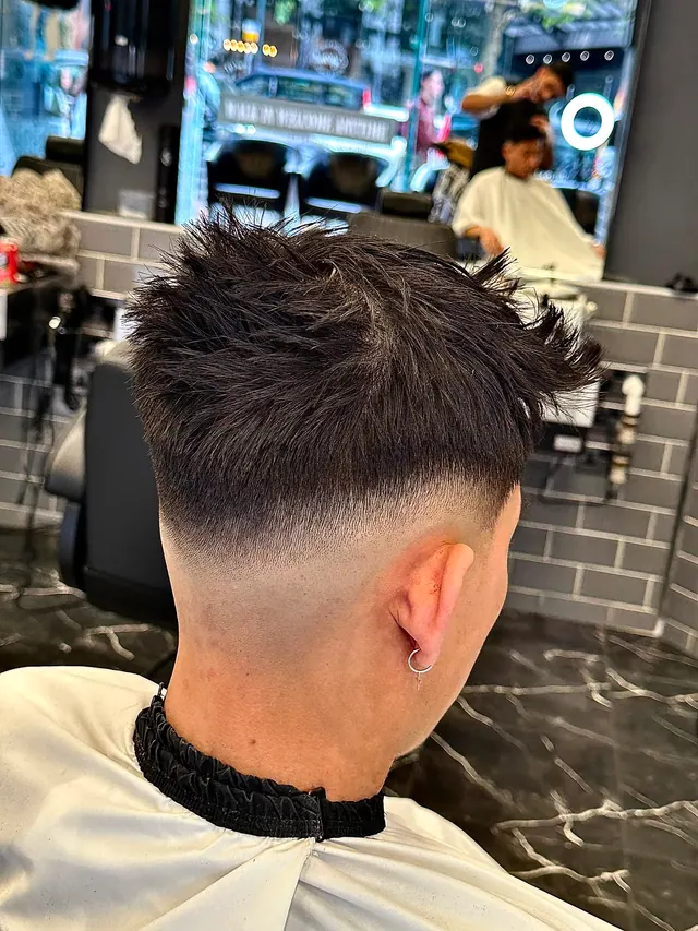 A textured crop with a high skin fade, seen from behind